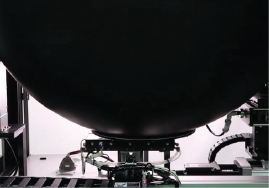 Close-up of integrating sphere used in LED tester machine for measuring luminous flux and color accuracy