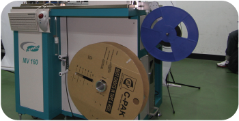 Tape and reel machine output section with final packaged components on carrier reel | MV160